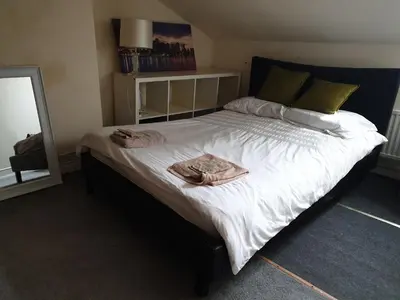 a bedroom with a large bed with two towels on it at Townsend Studio/Rooms in Liverpool