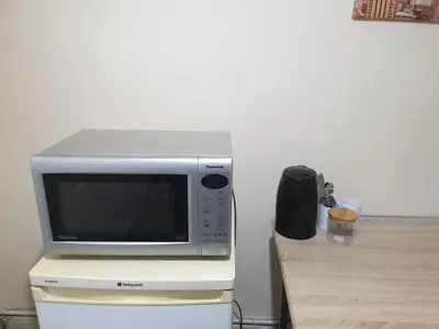a microwave oven sitting on top of a refrigerator at Townsend Studio/Rooms in Liverpool