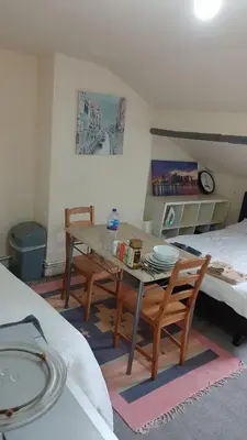 a room with a table and chairs and a bed at Townsend Studio/Rooms in Liverpool