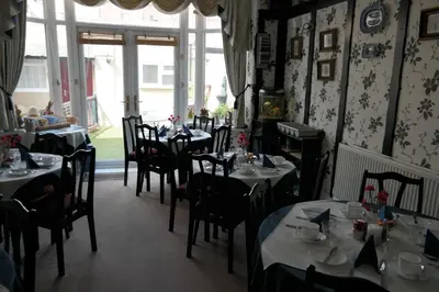 a restaurant with tables and chairs in a room at OLIVERS Strickley over 35 years only in Blackpool