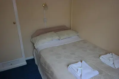 a small bed in a room with towels on it at OLIVERS Strickley over 35 years only in Blackpool