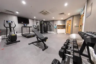 a gym with treadmills and machines in a room at Holiday Inn Blackpool by IHG in Blackpool