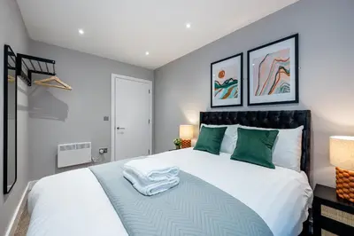 a bedroom with a large white bed with green pillows at Host & Stay - Henry Street Chambers in Liverpool