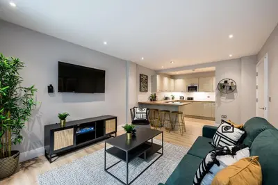 a living room with a green couch and a table at Host & Stay - Henry Street Chambers in Liverpool