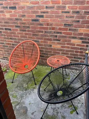 two orange chairs sitting next to a brick wall at The First-central Wigan 8 guests in Wigan