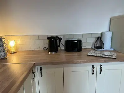 a kitchen with a counter top with a coffee maker at The First-central Wigan 8 guests in Wigan
