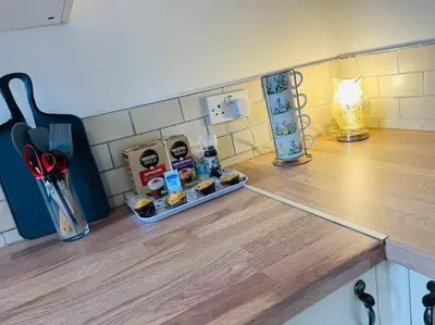 a kitchen counter with a tray of food on a counter top at The First-central Wigan 8 guests in Wigan