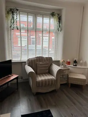 a living room with a couch and a window at The First-central Wigan 8 guests in Wigan