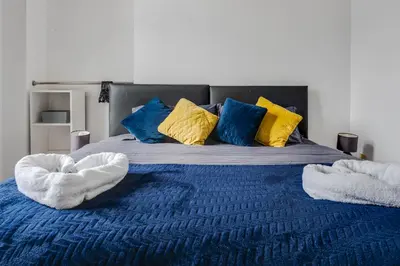 a bed with two white towels on top of it at Kinetic Stays - Symphony Building in Liverpool