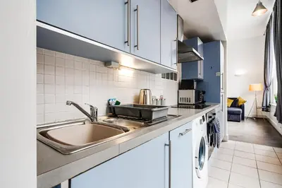 a kitchen with a sink and a dishwasher at Kinetic Stays - Symphony Building in Liverpool