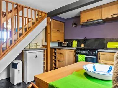 a kitchen with wooden cabinets and a wooden table at Quaint Cottage Retreat in Charming Ulverston - Pass the Keys in Ulverston