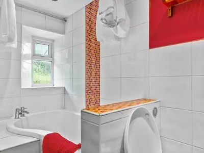 a white bathroom with a tub and a toilet at Quaint Cottage Retreat in Charming Ulverston - Pass the Keys in Ulverston