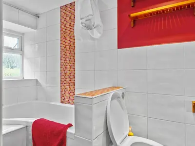 a white bathroom with a toilet and a bath tub at Quaint Cottage Retreat in Charming Ulverston - Pass the Keys in Ulverston