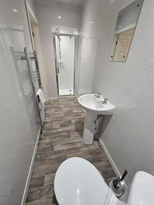 a bathroom with a toilet and a sink at 52 Wordsworth Street by Prestige Properties SA in Barrow in Furness