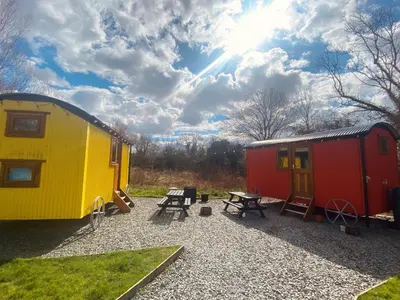 a yellow and red trailer and a picnic table at The Hamlet at Samlesbury Hall in Balderstone