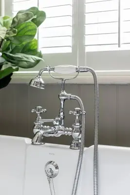 a bathroom sink with a faucet and a shower at The Gatehouse at Samlesbury Hall in Samlesbury