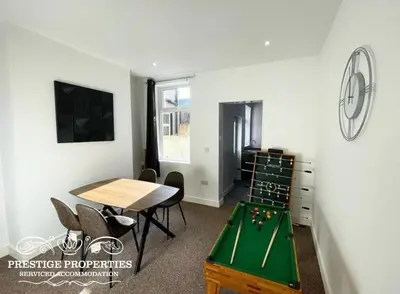 a room with a ping pong table and a room with at 38 Gloucester street by Prestige Properties SA in Barrow in Furness