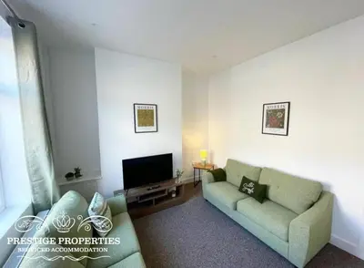 a living room with a couch and a tv at 38 Gloucester street by Prestige Properties SA in Barrow in Furness