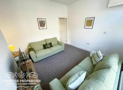 a living room with two couches and a couch at 38 Gloucester street by Prestige Properties SA in Barrow in Furness