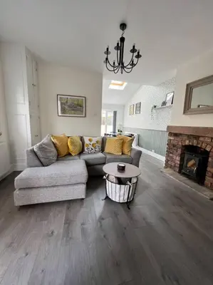 a living room with a couch and a fireplace at Cottage in Whalley in Whalley