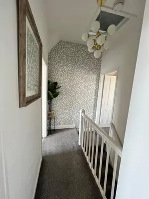 a hallway with a staircase with a ceiling fan at Cottage in Whalley in Whalley