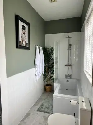 a bathroom with a tub and a toilet and a sink at Cottage in Whalley in Whalley