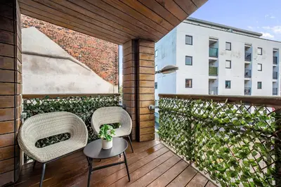 a patio with two chairs and a table on a balcony at Host & Stay - Ropewalks Quarters in Liverpool