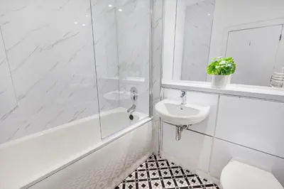 a white bathroom with a sink and a tub and a toilet at Host & Stay - Ropewalks Quarters in Liverpool
