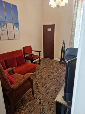 a living room with a couch and a tv at Vance House in Blackpool