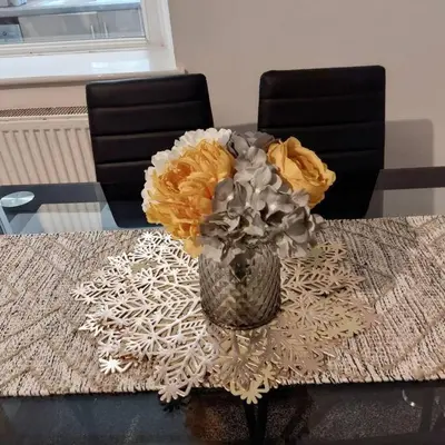 a vase of flowers sitting on a table at 4 Double Bedroom House in Accrington sleeps 6 in Accrington