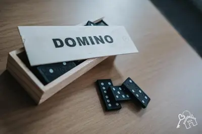 a box with dominoes next to a couple of remotes at 2 Bed Laburnum House - Free Parking & Private Yard in Blackpool