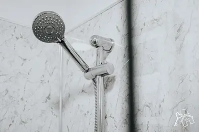 a shower with a shower head in a bathroom at 2 Bed Laburnum House - Free Parking & Private Yard in Blackpool