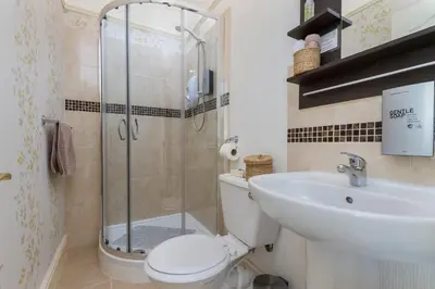 a bathroom with a shower and a toilet and a sink at The Beechcliffe Hotel - Over 35's Only in Blackpool