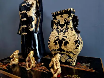 a black and white vase and figurines on a table at The Studio in Preston