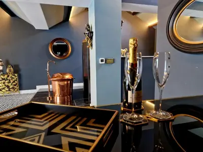 a dining room with a black counter with glasses on it at The Studio in Preston