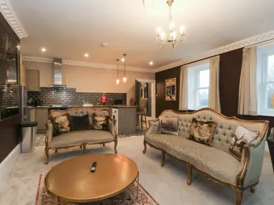 a living room with two couches and a table at Alexander in Preston