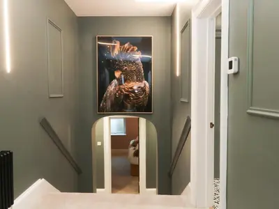 a hallway with a mirror and a picture on the wall at Alexander in Preston