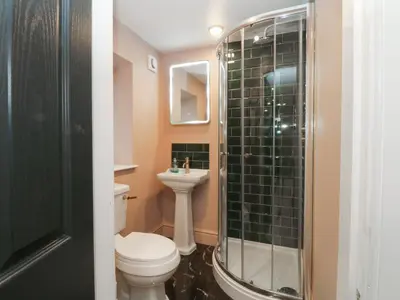 a bathroom with a toilet and a sink and a shower at Alexander in Preston