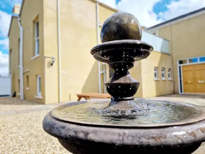 a water fountain in front of a building at Alexander in Preston