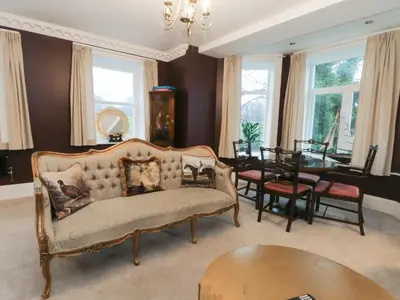 a living room with a couch and a table at Alexander in Preston