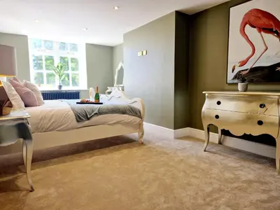a bedroom with a bed with a painting of a flamingo at The Duke in Preston