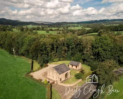 an aerial view of an old house in a field at Dusty Clough Barn in Preston