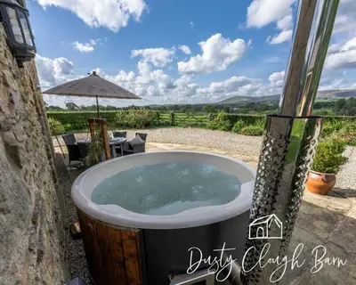 a jacuzzi tub outside of a house at Dusty Clough Barn in Preston