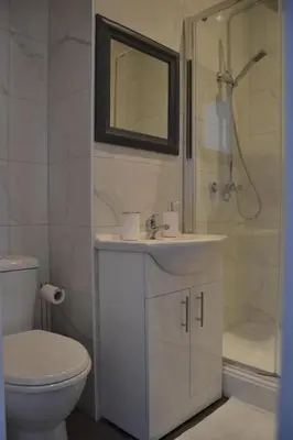 a bathroom with a toilet and a sink and a shower at The Glenbuck Hotel Anfield in Liverpool