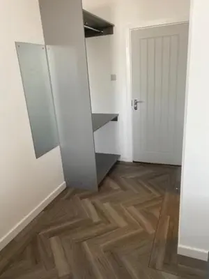 a room with a mirror and a wooden floor at The Glenbuck Hotel Anfield in Liverpool