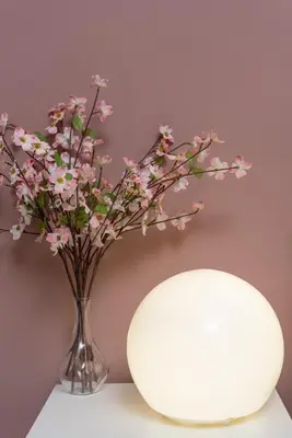 a vase filled with pink flowers on a table at Riversleigh in Warton