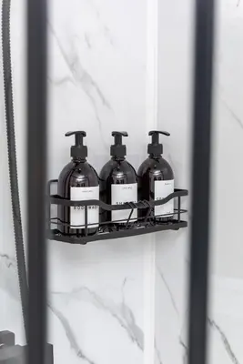 three bottles of soap on a shelf in a bathroom at Riversleigh in Warton