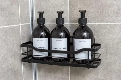 three bottles of wine on a shelf in a bathroom at Riversleigh in Warton