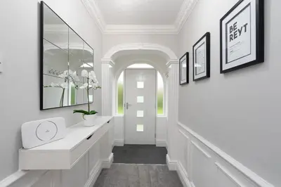 a hallway with white walls and a white door at Riversleigh in Warton