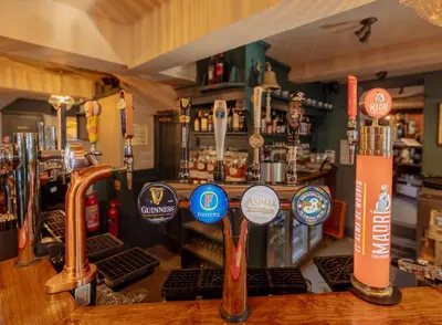 a bar with a counter with different types of alcohol at Ye Olde Original Withy Trees in Bamber Bridge